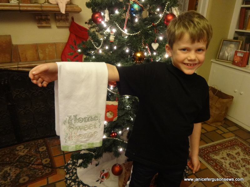 Alastair with the dishtowel he embroidered for his mother.